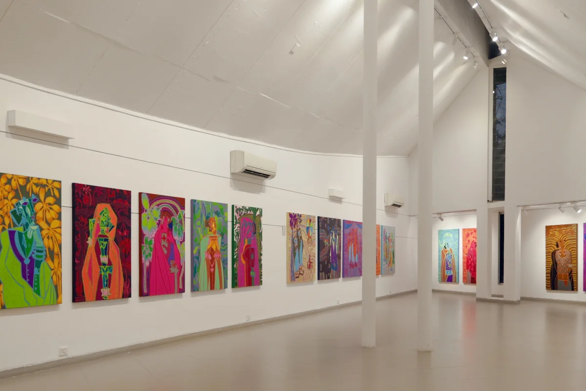 Colourful contemporary paintings displayed inside Urmila Art Gallery at Kanoria Centre for Arts in Ahmedabad.